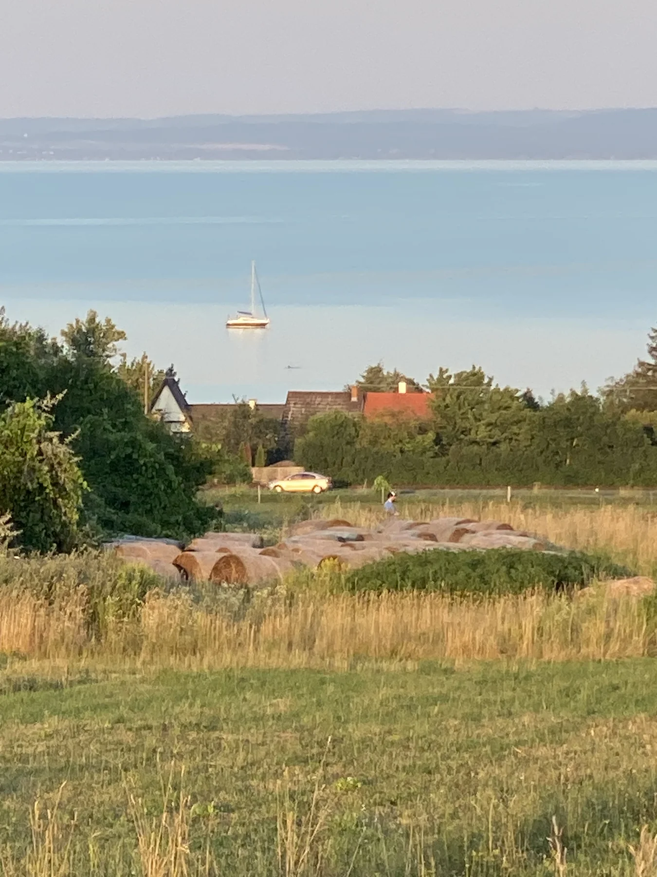 A Balaton a falu háztetői fölött